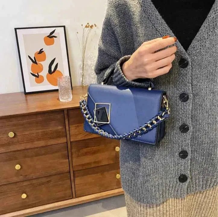 Emma – Textured crossbody bag with chain detail and geometric clasp