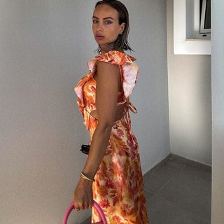 Liora – Feminines Maxikleid mit Volants und Cut - Outs im Aquarell - Print - Cecile LavelleOrange